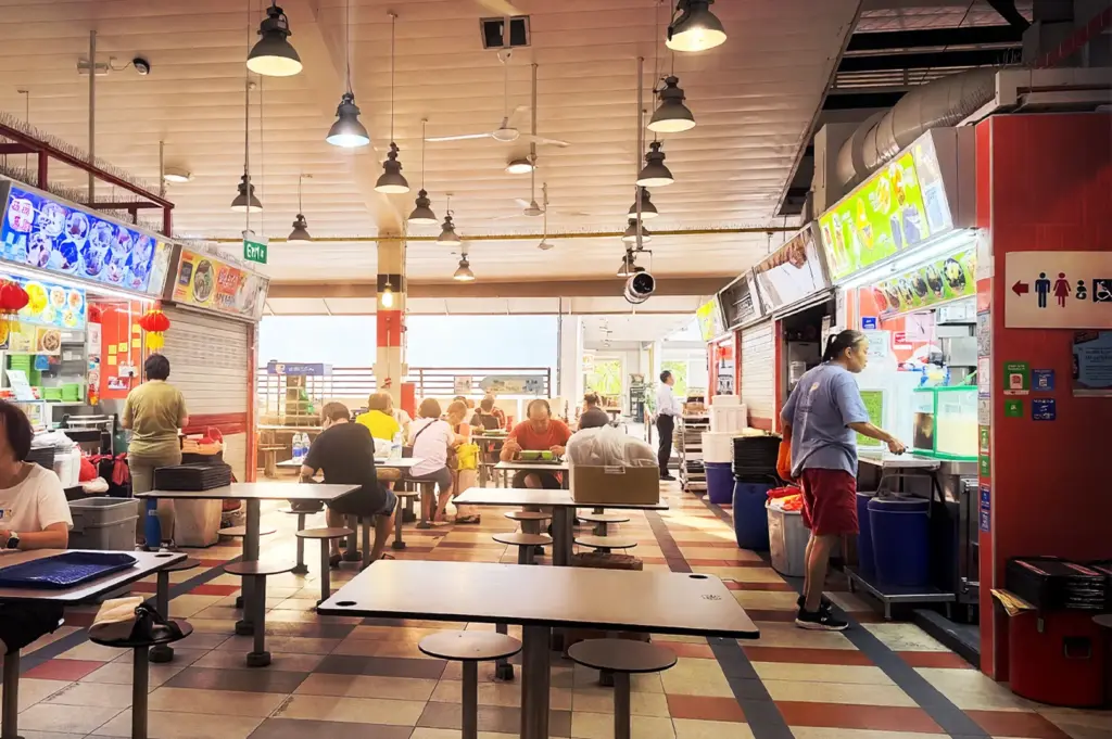 The interior layout of Tanjong Pagar Plaza Market & Food Centre, showcasing rows of food stalls and open seating areas where residents and office workers gather throughout the day for traditional Singaporean street food.