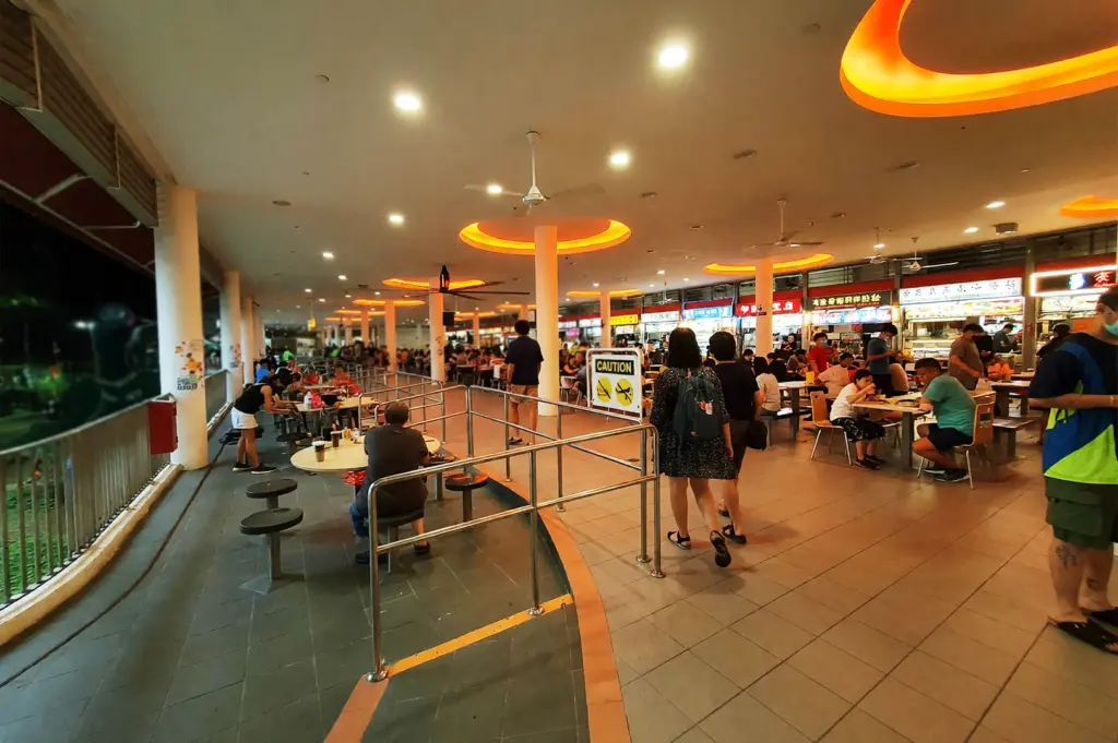 Elevated view of the Tiong Bahru Market food centre, illustrating how the building's circular architecture and open floor plan create natural pathways and seamless circulation for diners.