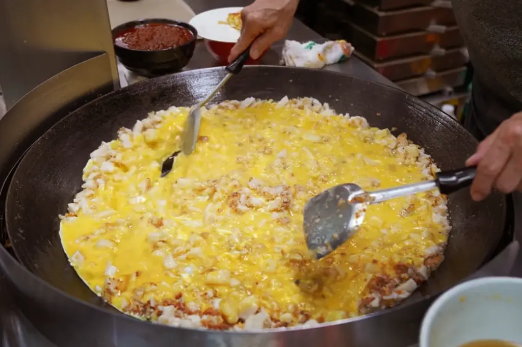 Mid-preparation—spatula lifting a portion from the surface