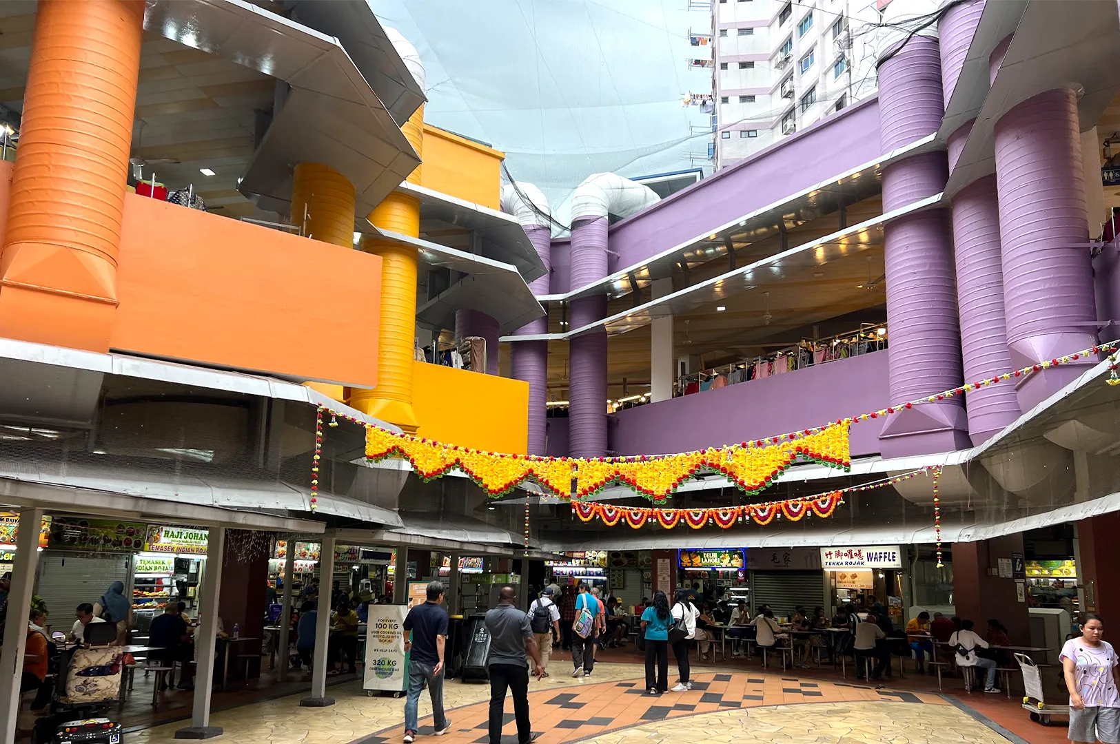 Morning light entering Tekka Centre as stalls begin their routine