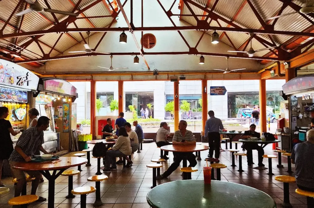 Interior of Maxwell Food Centre—rows of stalls surrounding shared seating